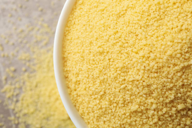 istock Bowl with raw couscous on gray background 1281019581