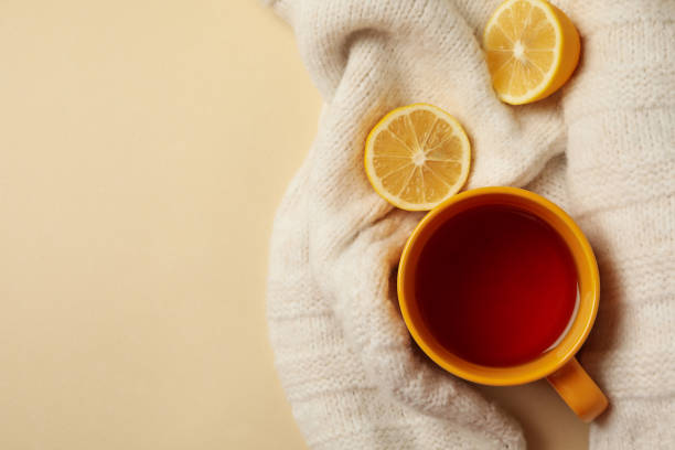 istock Sweater with cup of tea and lemons on beige background 1281020840