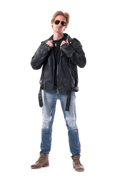 istock Confident redhead rocker or biker getting dressed put on leather jacket 1281021320