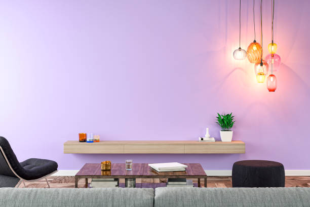 Empty nostalgic living room with gray sofa, lounge chair, pouffe, table and decoration in front of lavender plaster wall background