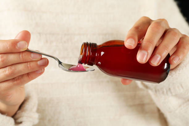 istock Woman pouring syrup in spoon, close up 1281022011