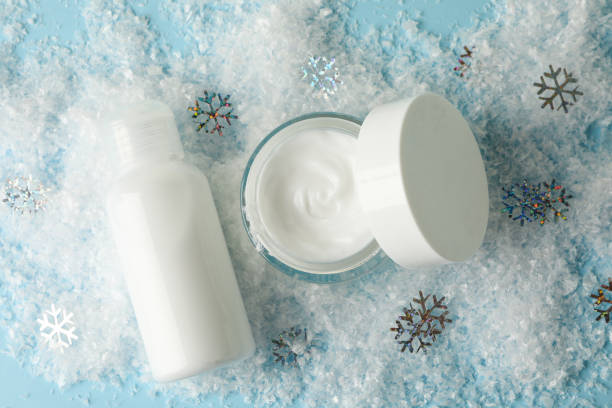 istock Cosmetics on blue background with decorative snow 1281022307