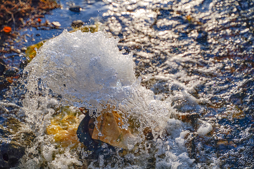 Water in the hot tub, with a water jet, produces bubbling stream for a relaxing massage.