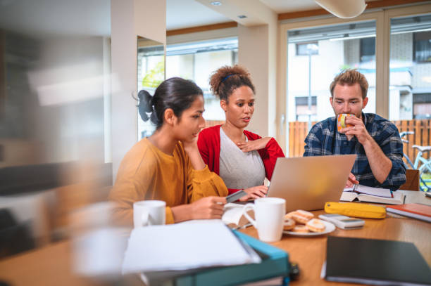 istock Caucasian, African-American and Indian Student Studying and Using Laptop While Sitting in Dining Room 1281022954