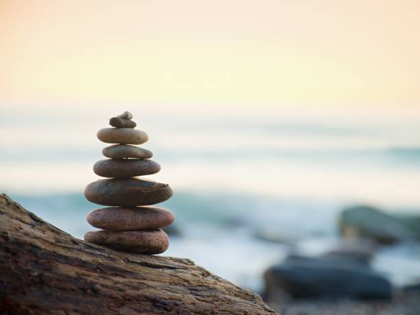 istock Balanced Stone Pyramide On Sea Shore, Waves In Background 1281024772