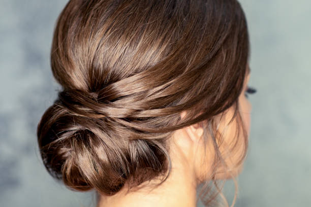 istock Brunette woman with middle bun hairstyle 1281025020