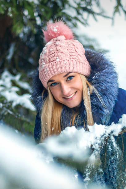 istock Young woman standing in winter forest 1281025091