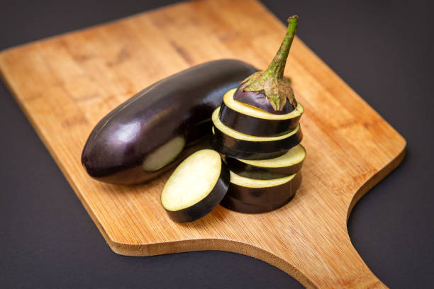 istock Eggplant on wooden cutting board 1281025801