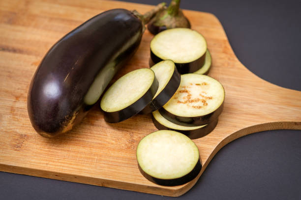istock Eggplant on wooden cutting board 1281025836