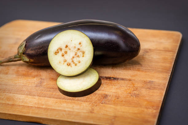 istock Eggplant on wooden cutting board 1281025874