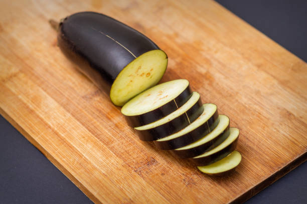 istock Eggplant on wooden cutting board 1281025965