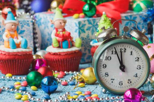 istock Christmas clock and cupcakes with colored decorations 1281034860
