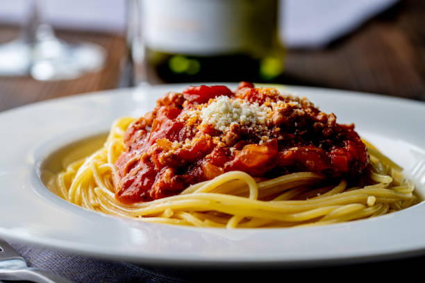 istock Pasta with meat and tomato sauce on wooden table. 1281035459