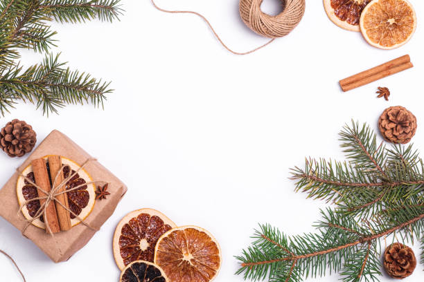 istock Christmas composition with handmade kraft paper gift box, dried citrus slices, cinnamon, anise, pine cones and fir tree branches, top view copy space 1281036809