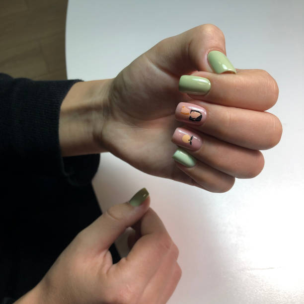istock Bright multi-colored design of manicure.Multicolored manicure close up 1281037432