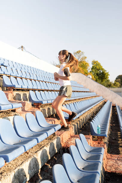 istock Girl doing sports alone in an empty track. 1281037565