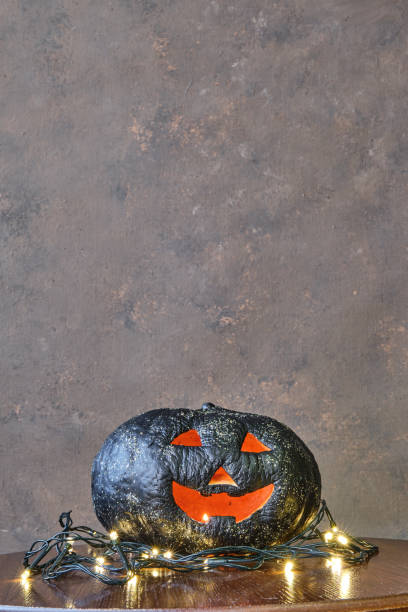 istock black colored pumpkin with glitter on wooden stool in front of a brown backdrop 1281037932