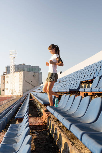 istock Girl doing sports alone in an empty track. 1281038294