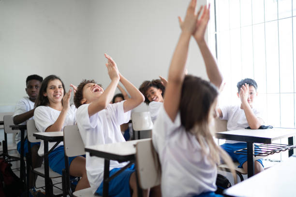 istock Elementary students celebrating in the classroom at school 1281039516