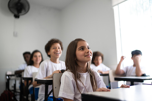 Portrait of a girl writing in the classroom