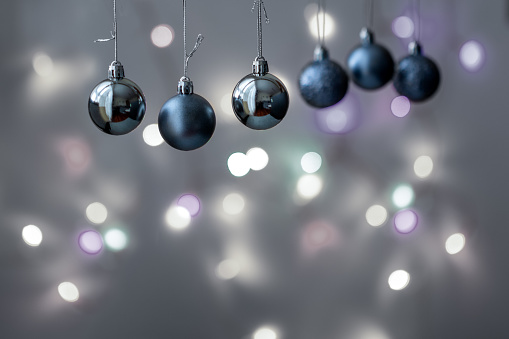 Gray baubles and bright light on the background