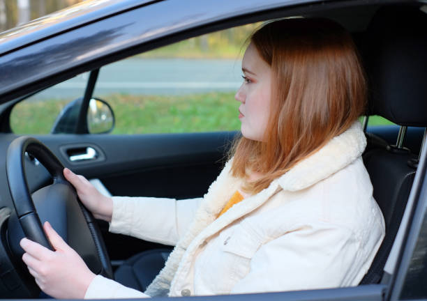 istock Young beautiful plus size women on driver's car 1281044178