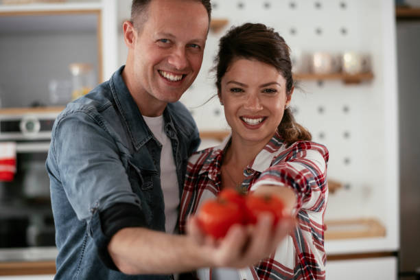 istock Husband and wife making salad 1281044729