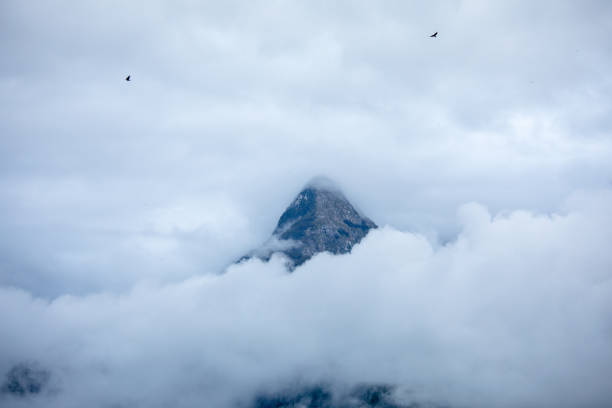 peak of mount vrh brda in bewteen clouds stock photo