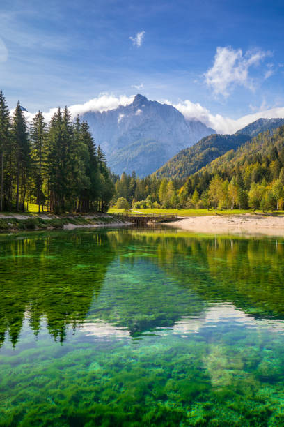 crystal clear lake Jasna with mountains in background stock photo
