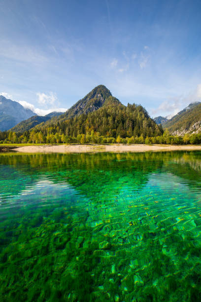 crystal clear lake Jasna with mountains in background stock photo