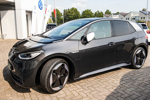 Kampen, The Netherlands - September 11, 2020: Volkswagen ID.3 all electric compact car in black front view parked outside a dealership in the city of Kampen after its market introduction in September 2020. The ID.3 is the first model of the I.D. Series and was presented in September 2019 with the first cars hitting the road in September 2020 after multiple delays. The VW ID.3 is available as Pure, Pro and Pro S with a range of 330 to 550 km.
