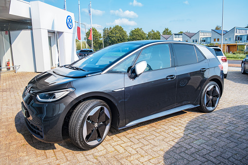 Kampen, The Netherlands - September 11, 2020: Volkswagen ID.3 all electric compact car in black front view parked outside a dealership in the city of Kampen after its market introduction in September 2020. The ID.3 is the first model of the I.D. Series and was presented in September 2019 with the first cars hitting the road in September 2020 after multiple delays. The VW ID.3 is available as Pure, Pro and Pro S with a range of 330 to 550 km.