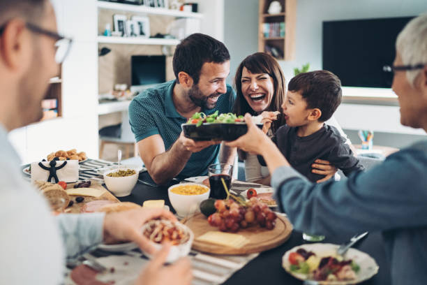 istock Extended family sharing the food on the table 1281046430