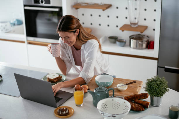 istock Beautiful woman preparing breakfast and drinking coffee 1281048035