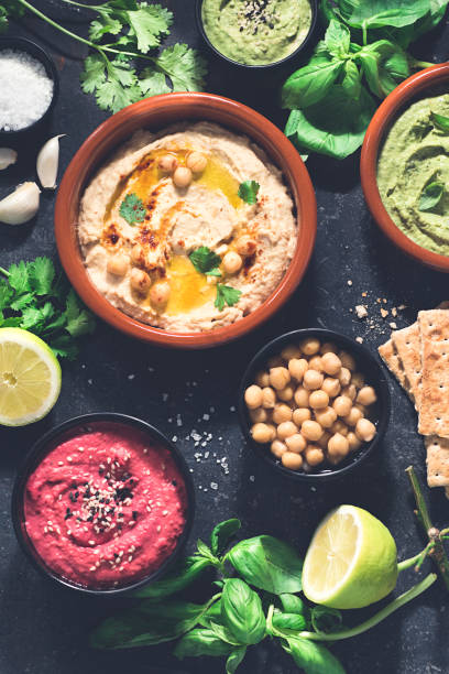 istock Vegetarian hummus based on herbs, basil and coriander on a dark rustic background, close up. Healthy vegetarian food concept 1281050620