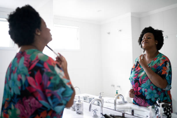 istock Beautiful woman applying make-up at home 1281050822