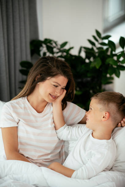 istock Happy parents with sons relaxing in bed. 1281051709