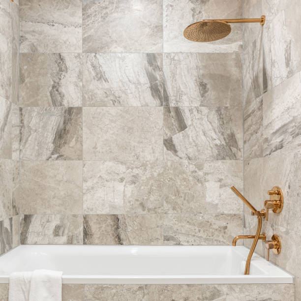 istock Bathtub in bathroom with beige tiles 1281054563
