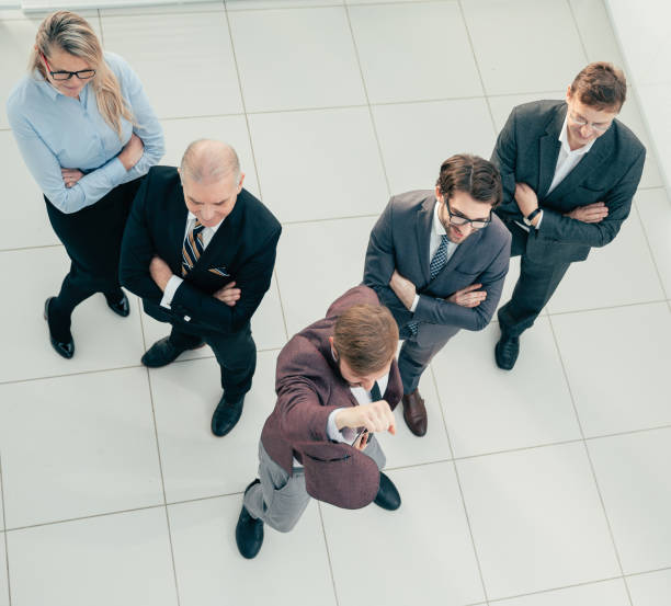 istock top view. leader and a group of employees standing together 1281055281