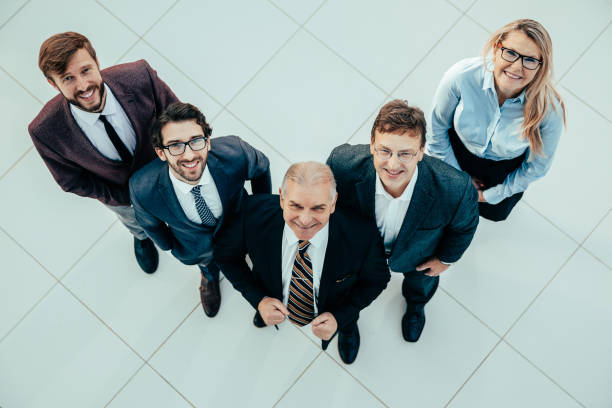 istock top view. a group of happy business people looking at the camera 1281055430