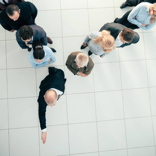 istock top view. a confident businessman leading his team forward 1281055447