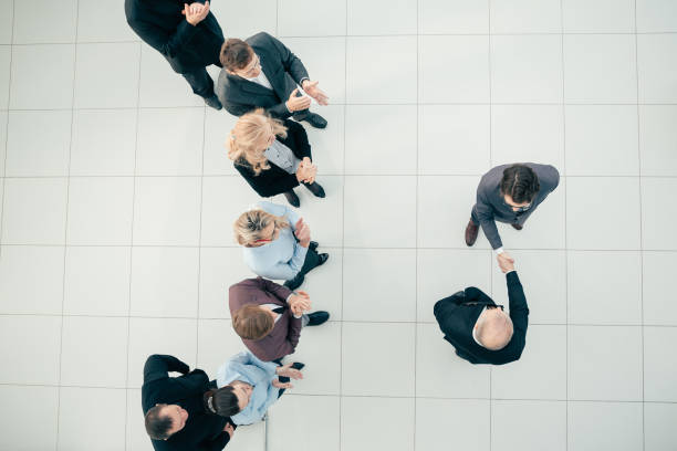istock top view. business men firmly shake hands 1281055492
