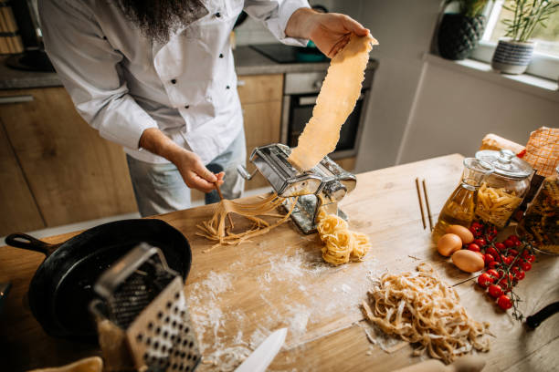 istock Bearded man in kitchen, cooking pasta for lunch 1281060290