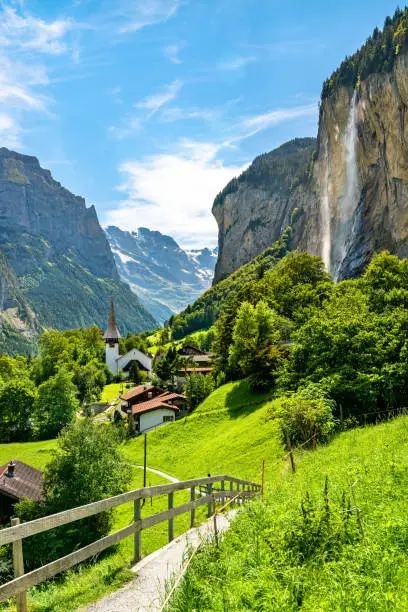 The village church and the Staubbach Falls in Lauterbrunnen - the canton of Bern, Switzerland