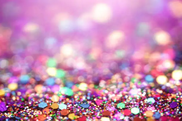 Colorful confetti glitter background macrophotography with selective focus and copy space. Perfectly usable for all party related projects.