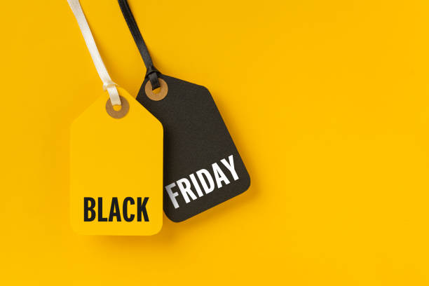 istock Sale tags with Black Friday written on yellow background 1281062761