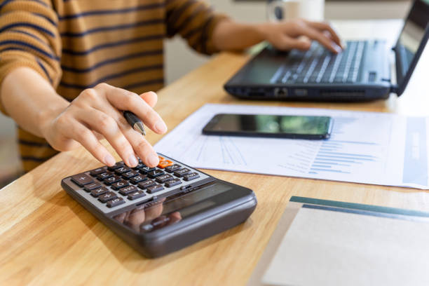 istock Businessman with calculator and laptop. 1281062817