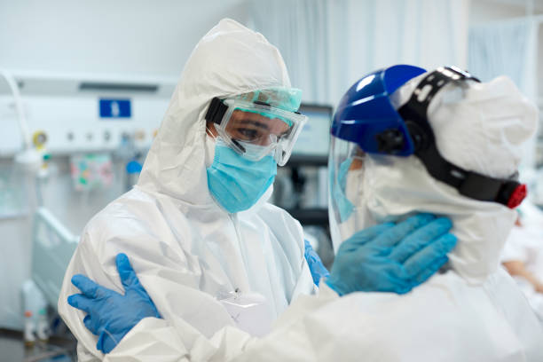 istock Medical Team in Protective Workwear Embracing in Support 1281063058