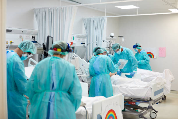 istock General view of an intensive care unit with doctors in protective workwear and patients 1281063077