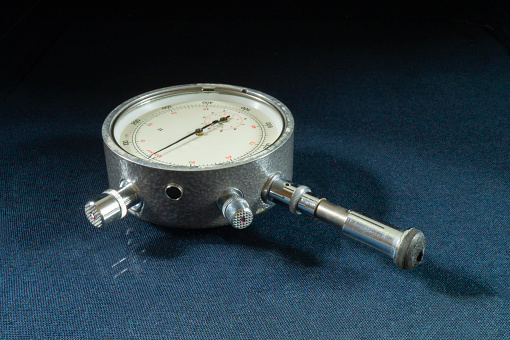 The Mechanical tachometer with arrow on black background. Instrument for measurement turn gross on engine